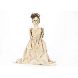 A late 18th century English carved and painted wooden doll, with dark enamelled eyes, faint