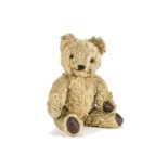 A Tara laughing teddy bear 1950s, with golden mohair, orange and black glass eyes, black stitched