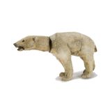 A rare German clockwork nodding polar bear 1920s, cardboard and composition covered in white mohair,