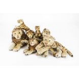 Seven post-war Steiff lions and tigers: four reclining lions, reclining tiger and two running