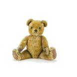 A Twyford Farnell-type teddy bear 1950s, with dark golden mohair, orange and black glass eyes, black