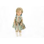 An interesting Käthe Kruse style doll, with stiffened painted cloth head, blue painted eyes,