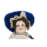 An Armand Marseille 390n child doll, with blue lashed sleeping eyes, brown mohair wig, jointed