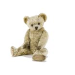 A rare early Terrys teddy bear circa 1920, with blonde mohair, clear and black glass eyes with