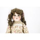 A Limoges bisque headed doll marked C C, with fixed blue side drooping eyes, pierced ears,