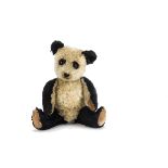 A rare Chiltern Hugmee panda 1950s, with black and white mohair, orange and black glass eyes with