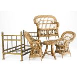 A doll’s brass bedstead, with foot and head board -19in. (48cm.) long; and a wicker settee, two