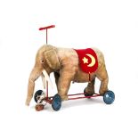 A Steiff 1930s ride on elephant on wheels, with grey mohair, replaced eyes, pull-cord growl, metal