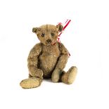 An early Steiff centre-seam teddy bear 1908, with cinnamon mohair, black boot button eyes,