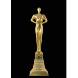 Asia Pacific Brands Foundation Award, 2014 gilt metal figure clasping a crystal, on raised stand