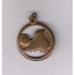 BRASS FOOTBALL Small brass circular medal with fob, shows a brass football boot kicking a ball.