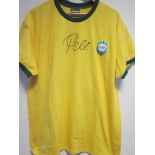 PELE SIGNED SHIRT A yellow Brazil replica short sleeve shirt issued by Copa Mundo with plastic