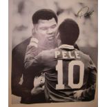 PELE AUTOGRAPHED CANVAS A large 28" X 24" black & white action canvas showing Pele embracing