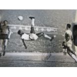 PELE AUTOGRAPHED PHOTO A large 20" X 16" black & white action photograph showing Pele executing an