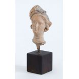 GREEK TERRACOTTA HEAD OF A WOMAN, HELLENISTIC