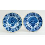 TWO SIMILAR DUTCH BLUE AND WHITE DELFT PEACOCK PLATES