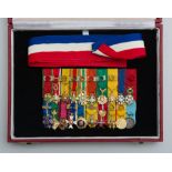 GROUP OF TWENTY DIPLOMATIC SMALL RIBBONED BADGES, MOUNTED TOGETHER AND CASED