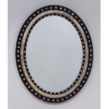 ANGLO-IRISH EBONIZED AND SILVER-GILT OVAL MIRROR