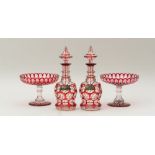 PAIR OF OVERLAY RUBY GLASS DECANTERS AND STOPPERS AND A PAIR OF OVERLAY RUBY GLASS STEMMED COMPOTES