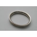 A solid silver bangle.