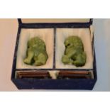 A pair of 20th century Jade temple dogs in a fitted case on a hardwood stand. 12cm