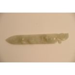 A Chinese white jade paper knife with relief carved decoration. Approximately 20cm long