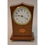 An inlaid mantle clock with sloped top