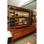 An oak 19th Century welsh dresser, the open back with three shelves above three drawers on