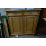 A Victorian stripped pine cupboard fitted two draw