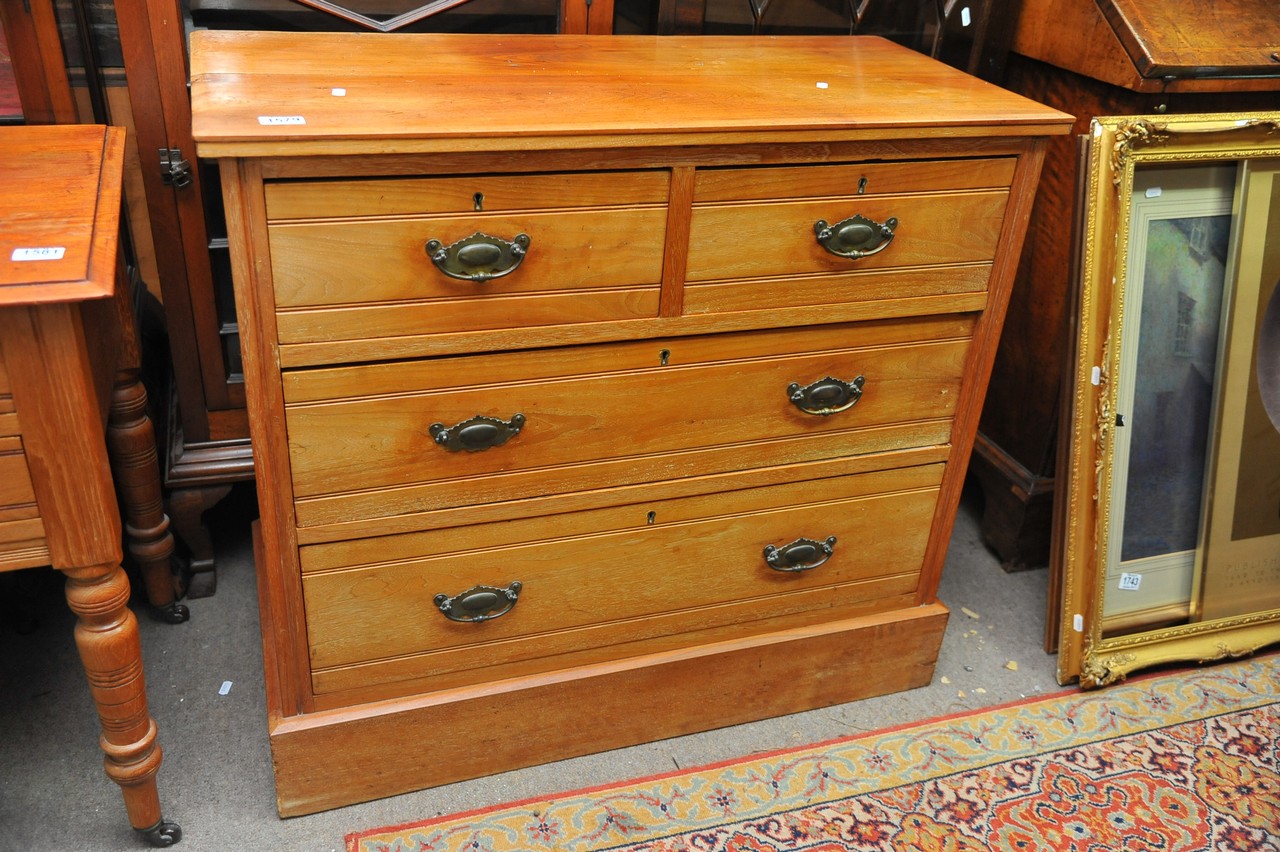 A Walnut chest of drawers fitted with two short an