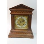 A large J. B Benson carved wood clock with gilt me