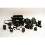 A box of Olympus camera equipment including many l