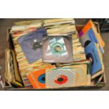 A box containing a collection of 1950s - 60s 45rpm