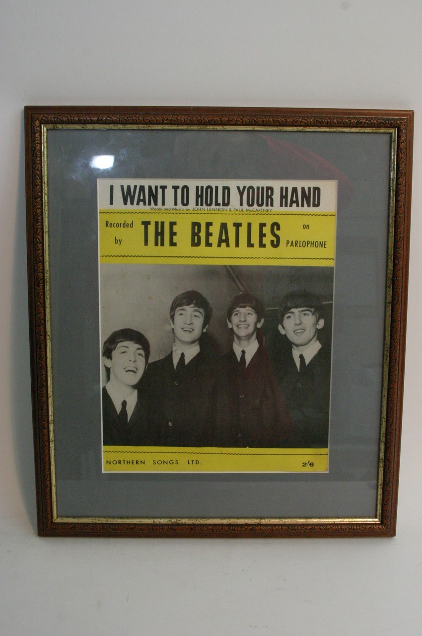 Framed and glazed sheet music of The Beatles song 'I want to hold your hand' with signatures