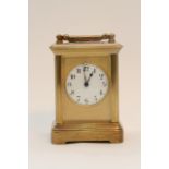 A miniature brass carriage clock