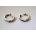 A small pair of platinum and diamond set hoop earrings