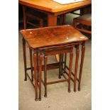 A nest of 3 walnut occasional tables on square tapering legs and pad feet