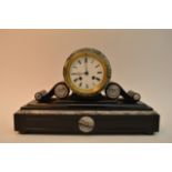 A black and white marble mantle clock with key