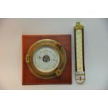 A brass, wood mounted Nauticalia barometer with an