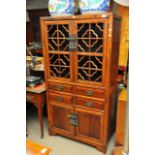 A 20th century oriental Cabinet with open fretwork doors above drawers and cupboards