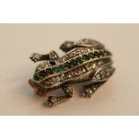 A quality gold and diamond set frog brooch having single row of emeralds to back and ruby eyes, some