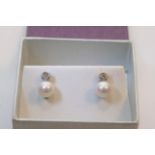 A pair of 18ct white gold diamond and pearl set stud earrings