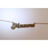 A 9ct gold necklace bearing the name 'Maxine'.