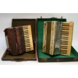 Two cased accordions.