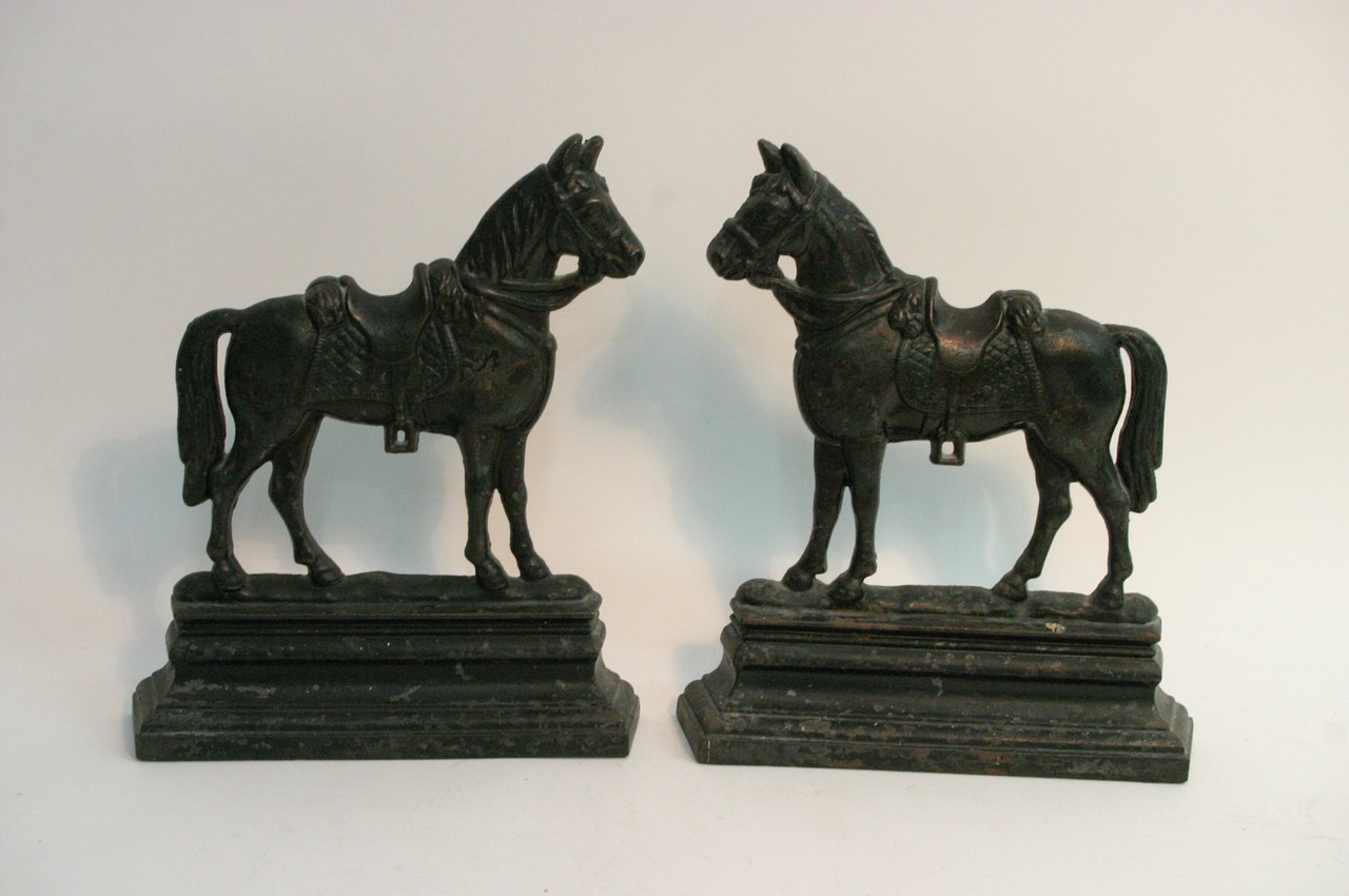 Pair of cast iron doorstops in the form of horses