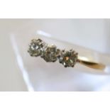 An 18ct yellow gold three stone diamond ring, appr