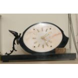 An Art Deco onyx type mantle clock of oval shape a