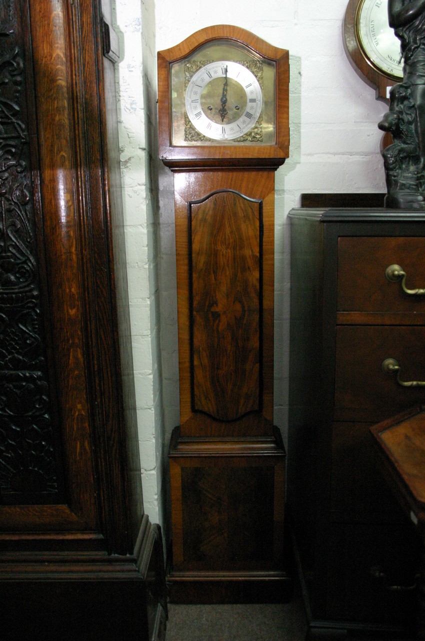 A Grandmother clock with brass face