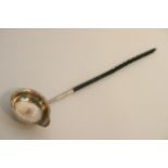 A silver toddy ladle with whale bone handle and a