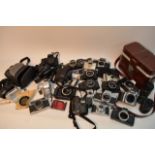 A collection of vintage 35mm film cameras and acce